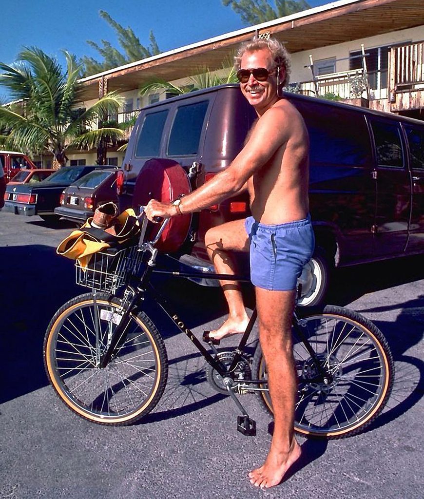 Jimmy Buffet barefoot on a bicycle in Key West